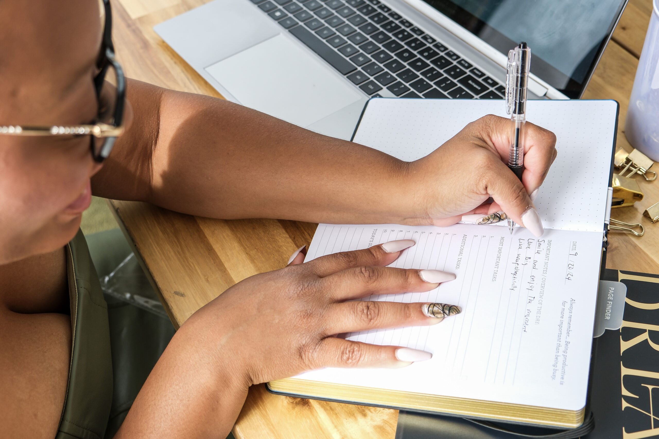 women entrepreneur writing in notebook